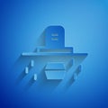 Paper cut Grave with tombstone and coffin icon isolated on blue background. Paper art style. Vector