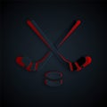 Paper cut Ice hockey sticks and puck icon isolated on black background. Game start. Paper art style. Vector Royalty Free Stock Photo