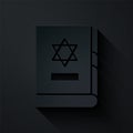 Paper cut Jewish torah book icon isolated on black background. On the cover of the Bible is the image of the Star of Royalty Free Stock Photo