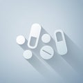 Paper cut Medicine pill or tablet icon isolated on grey background. Capsule pill and drug sign. Pharmacy design. Paper Royalty Free Stock Photo