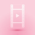 Paper cut Play Video icon isolated on pink background. Film strip with play sign. Paper art style. Vector