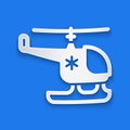 Paper cut Rescue helicopter icon isolated on blue background. Ambulance helicopter. Paper art style. Vector