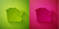 Paper cut Sand in bucket with shovel icon isolated on green and pink background. Plastic kid toy. Summer icon. Paper art style. Royalty Free Stock Photo