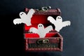 Paper Ghosts Fly Out Of An Old Vintage Wooden Chest On A Black Background, Festive Halloween Card
