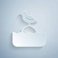 Paper cut Seagull sits on a buoy in the sea icon isolated on grey background. Paper art style. Vector