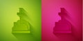 Paper cut Sword in the stone icon isolated on green and pink background. Excalibur the sword in the stone from the Royalty Free Stock Photo