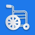 Paper cut Wheelchair for disabled person icon isolated on blue background. Paper art style. Vector Royalty Free Stock Photo