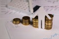 Paper cutout of a person in front of coins stacks Royalty Free Stock Photo