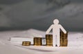 Paper cutout of a person in front of coins stacks Royalty Free Stock Photo