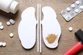 Paper cutout with sand, pills and hammer on wooden table, flat lay. Kidney stone disease Royalty Free Stock Photo
