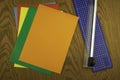 Paper cutter and color origami paper on a wooden table