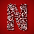 Paper cutting, white letter N . Red background. Floral ornament, balinese traditional style.