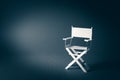 Paper director chair on a blueish grey background