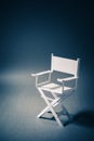Paper director chair on a blueish grey background