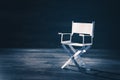 Paper director chair on a blueish grey background