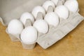 Paper Egg Tray with white eggs. chicken white eggs close up. beige background Royalty Free Stock Photo