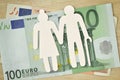 Paper elderly couple cut-out on euro banknotes - Pension concept