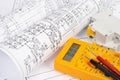 Paper electrical engineering drawings with circuit breaker and multimeter Royalty Free Stock Photo