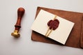 Paper envelope with red wax seal and stamp on a table, postal accessories Royalty Free Stock Photo