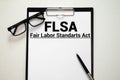 Paper with Fair Labor Standarts Act FLSA on a table