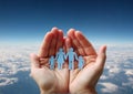 Paper family in hands on aerial sky view background Royalty Free Stock Photo