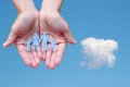 Paper family in hands on blue sky background welfare concept Royalty Free Stock Photo