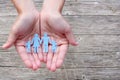 Paper family in hands on wooden background welfare concept Royalty Free Stock Photo