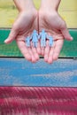 Paper family in hands on wooden coloured background welfare concept Royalty Free Stock Photo