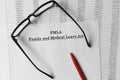 Paper with Family Medical Leave Act FMLA on a table Royalty Free Stock Photo