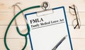 Paper with Family Medical Leave Act FMLA on a table Royalty Free Stock Photo