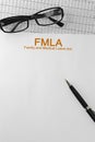 Paper with Family Medical Leave Act FMLA on a table Royalty Free Stock Photo