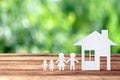 Paper family on wooden table with garden bokeh outdoor theme background Royalty Free Stock Photo