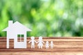 Paper family on wooden table with garden bokeh outdoor theme background Royalty Free Stock Photo