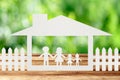 Paper family on wooden table with garden bokeh outdoor theme background Royalty Free Stock Photo