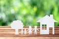 Paper family on wooden table with garden bokeh outdoor theme background Royalty Free Stock Photo