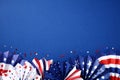 Paper fans in color of American flag on dark blue background. Happy American Independence Day, USA Labor day, Presidents Day Royalty Free Stock Photo