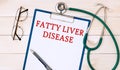 Paper with FATTY LIVER DISEASE on a table, stethoscope and glasses Royalty Free Stock Photo