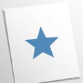 Paper features a centered blue five-pointed star, creating a Royalty Free Stock Photo