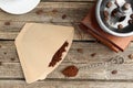 Paper filter, ground coffee and grinder on wooden table, flat lay Royalty Free Stock Photo