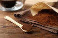 Paper filter and ground coffee on wooden table, closeup Royalty Free Stock Photo
