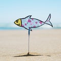 Paper fish on the beach in the summer