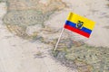 Ecuador flag pin on world map Royalty Free Stock Photo