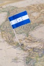 Honduras flag pin on a world map