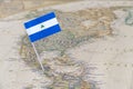 Nicaragua flag pin on world map Royalty Free Stock Photo