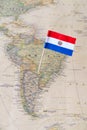 Paraguay flag pin on a world map Royalty Free Stock Photo