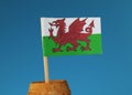 A paper flag of Wales, part of Great Britain, on wooden stick in wooden barrel