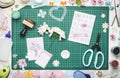 Paper flowers, a homemade card and tools for scrapbooking on the green mat for cutting Royalty Free Stock Photo