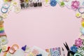 Paper flowers, scissors, paper and scrapbooking items on pink background Royalty Free Stock Photo