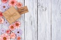 Paper flowers side border with Mother`s Day gift and tag over wood Royalty Free Stock Photo