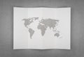 Paper folded with world map .